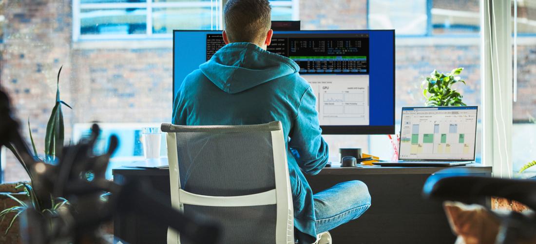 A data analyst working on a desktop computer