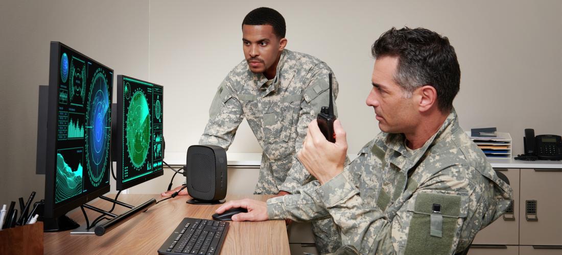 Two military employees at double-screen computer